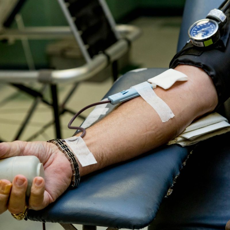 person on chair donating blood